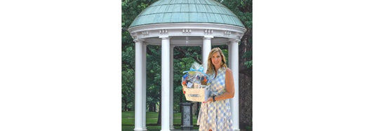 Owner of HandPicked Gifts in front of Old Well at UNC