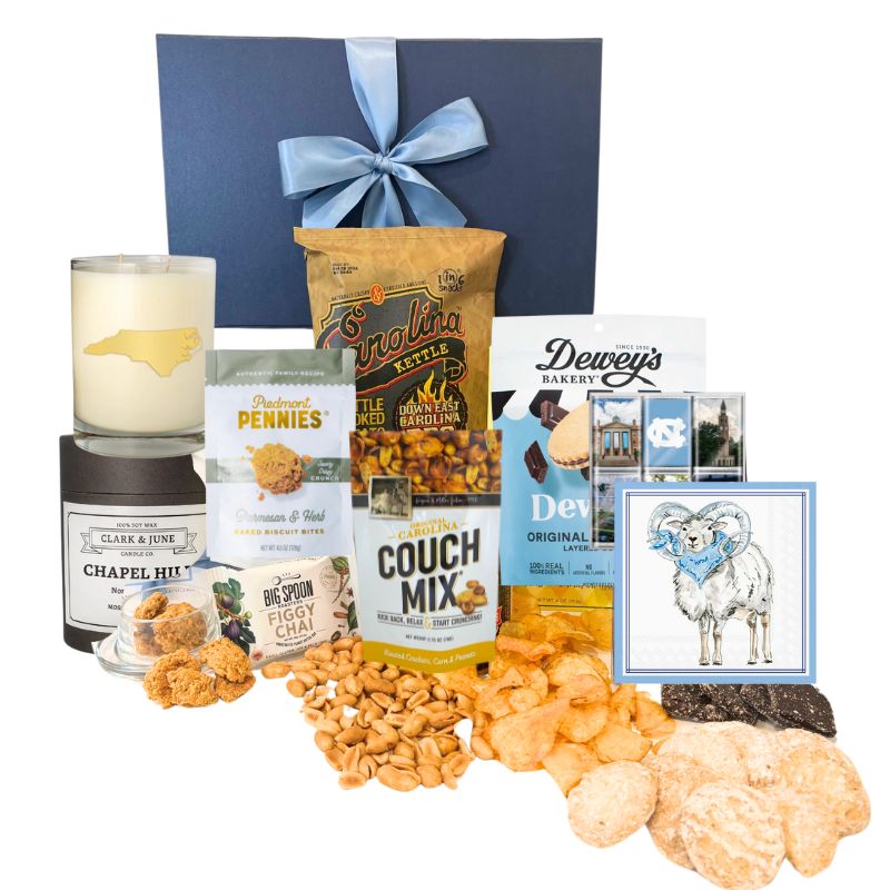 Chapel Hill Signature Gift Set featuring premium UNC gifts and locally made treats like chocolates, BBQ chips, and cheese wafers, displayed in front of the navy gift box