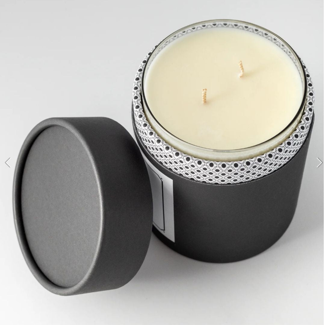 Top view of the Chapel Hill candle inside its black tube packaging with the lid removed, revealing the top of the candle and the sleek design.