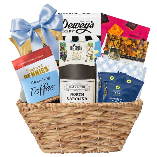 Gourmet Gift basket featuring a candle with the gold North Carolina silhouette and a variety of other made in North Carolina Gourmet foods.