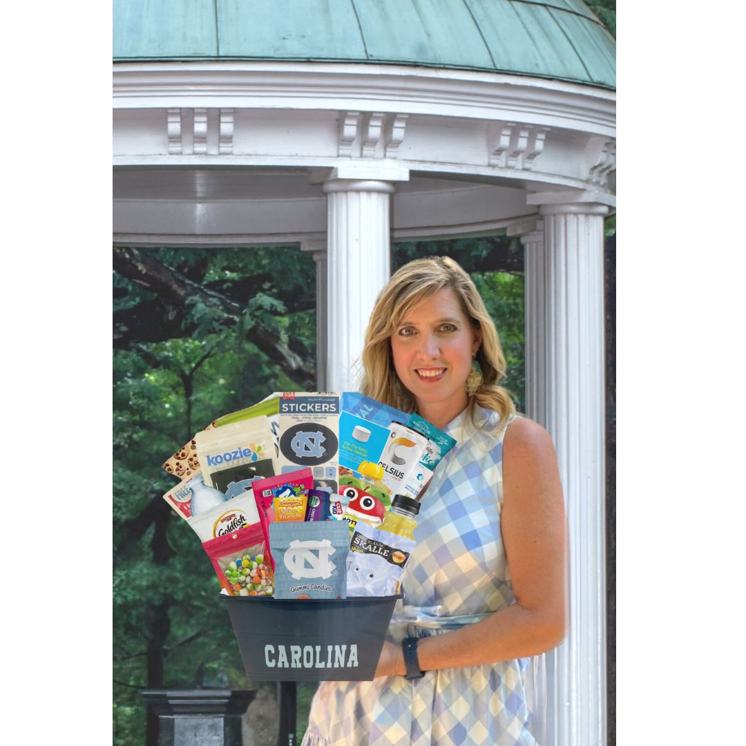 Owner of North Carolina Gift Delivery company standing in front of Chapel Hill's Old Well