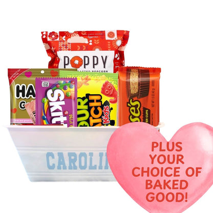 UNC Valentine’s Day Gift Basket filled with sweet treats including Haribo Gummy Bears, Poppy Popcorn, and more, plus customer's choice of fresh baked Valentine's treat all packaged in a Carolina plastic bucket