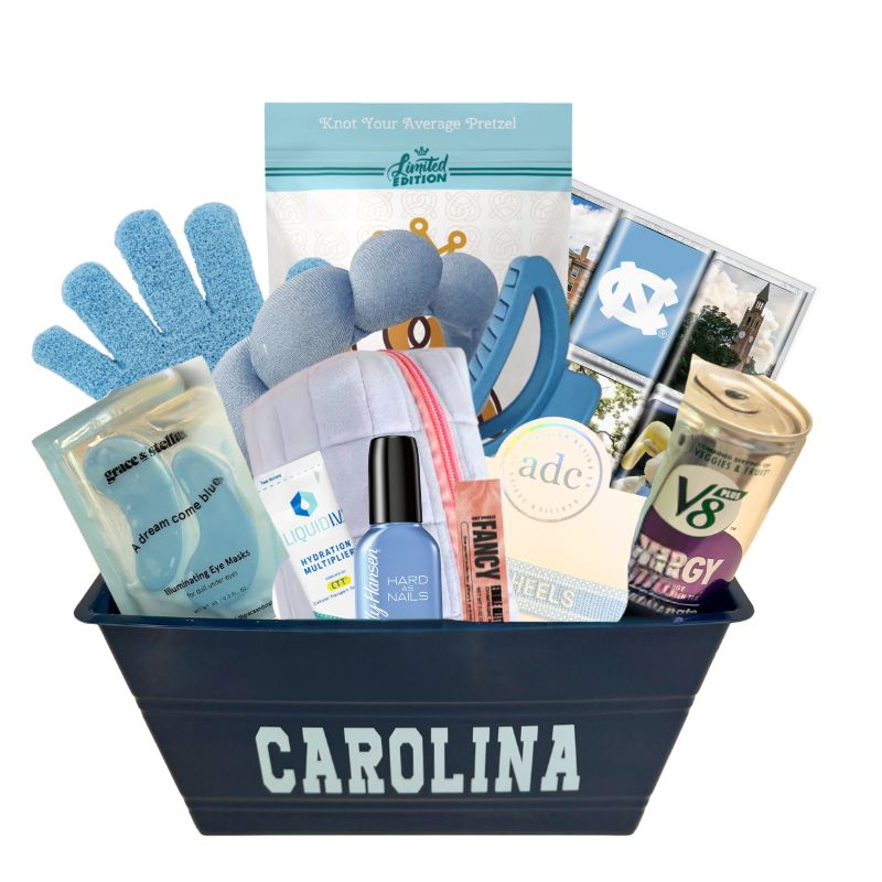 UNC Chapel Hill gift basket full of Carolina blue gifts for girls who enjoy self care, including a Tar Heels game day bracelet, UNC chocolates, cosmetic items, and made in North Carolina snacks