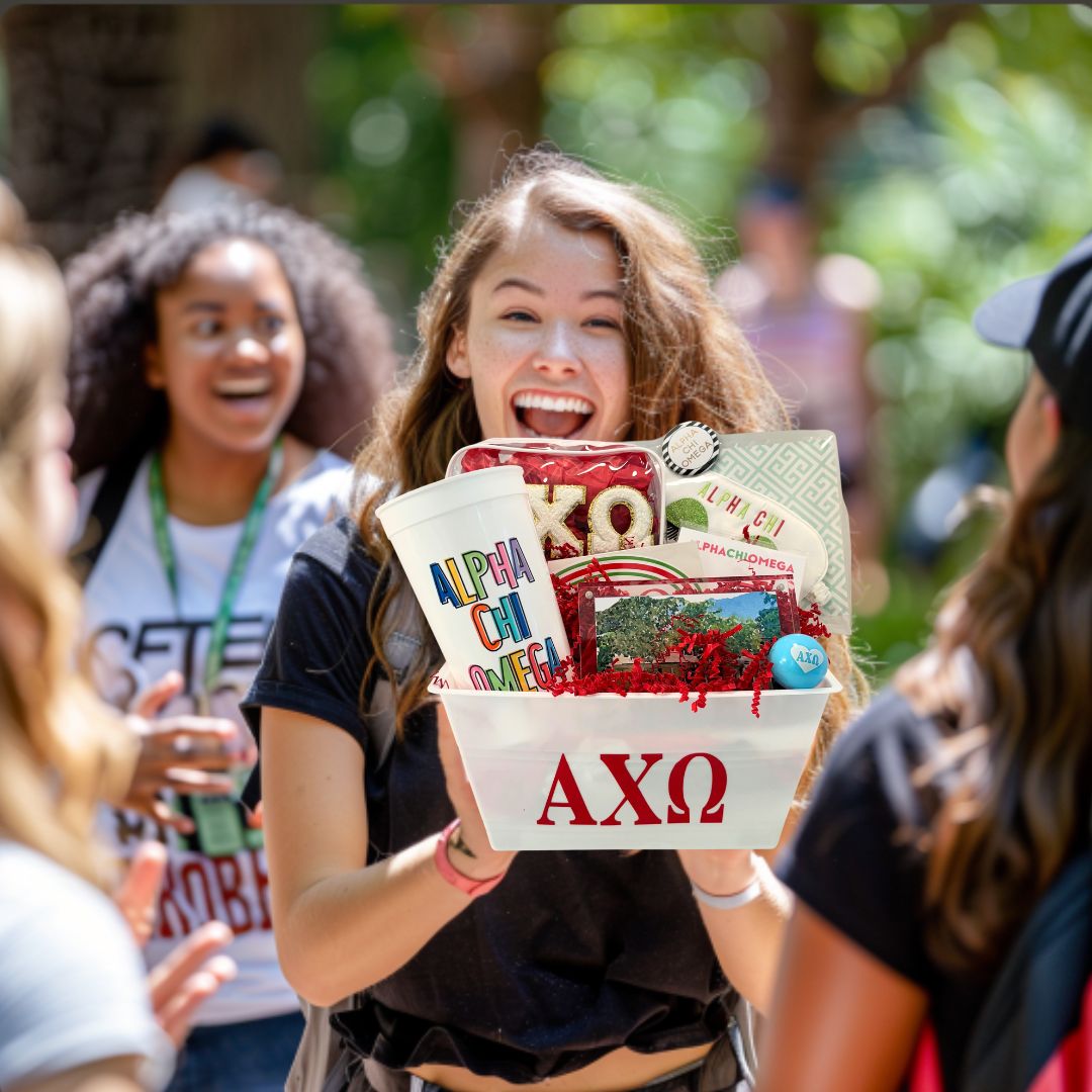 UNC Chapel Hill student holding a UNC sorority gift on Bid Day