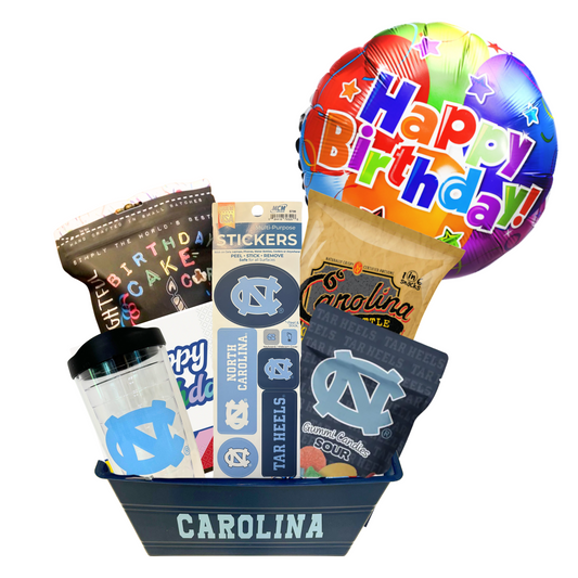 gift basket containing cookie cake, birthday popcorn, UNC stickers, UNC gummy candies, Carolina BBQ chips, and a UNC insulated cup. 