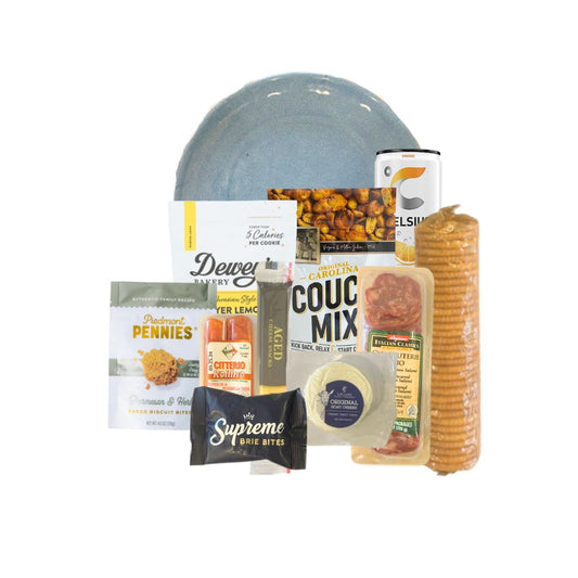 Chapel Hill Fresh & Healthy Charcuterie Box unpacked, featuring protein-rich snacks like cheese sticks, salami, nuts, crackers and a Carolina blue plate.