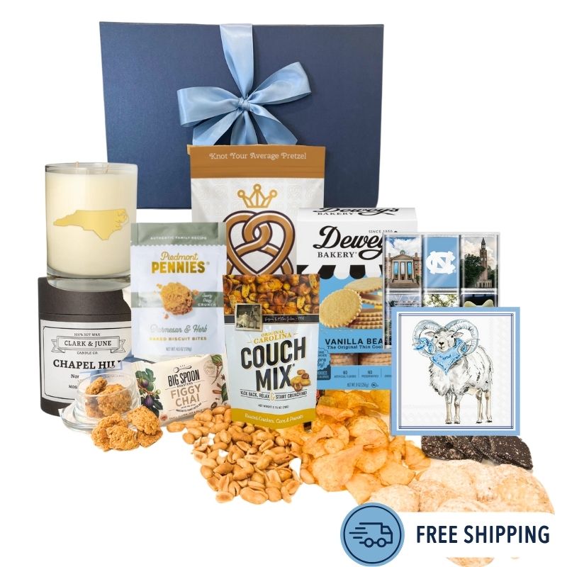 Chapel Hill Signature Gift Set featuring premium UNC gifts and locally made treats like chocolates, pretzels, and cheese wafers, displayed in front of the navy gift box